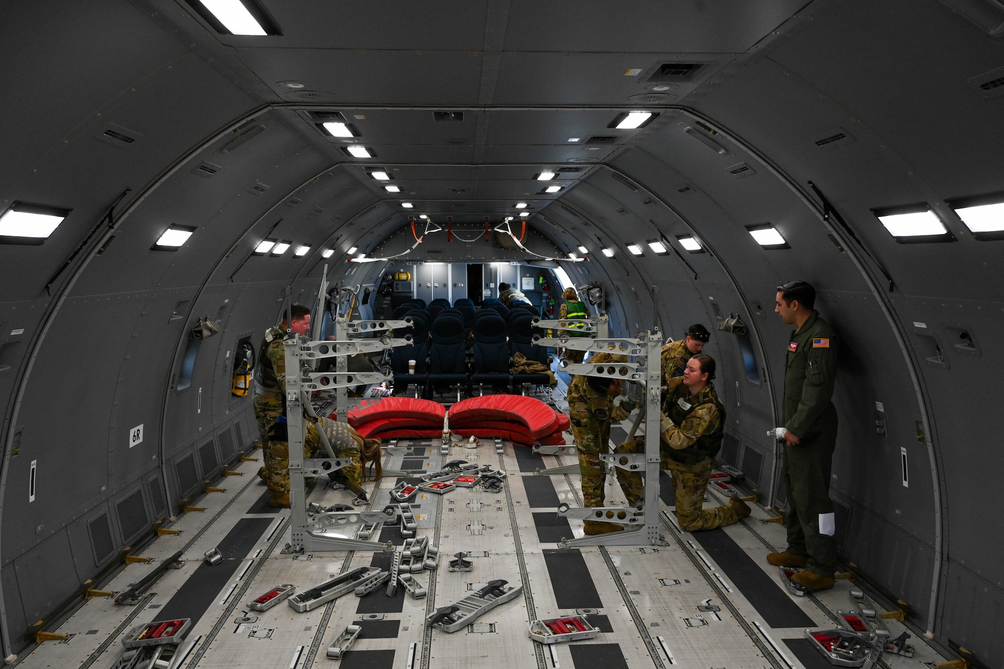 Airmen from the 375th Air Mobility Wing put together racking systems in the cargo area of a KC-46 Pegasus during Combat Cardinal 2024 at Scott Air Force Base, Illinois, March 13, 2024. Combat Cardinal is a series of exercises meant to enhance the wing’s ability to rapidly deploy. (U.S. Air Force photo by Senior Airman Trenton Jancze)