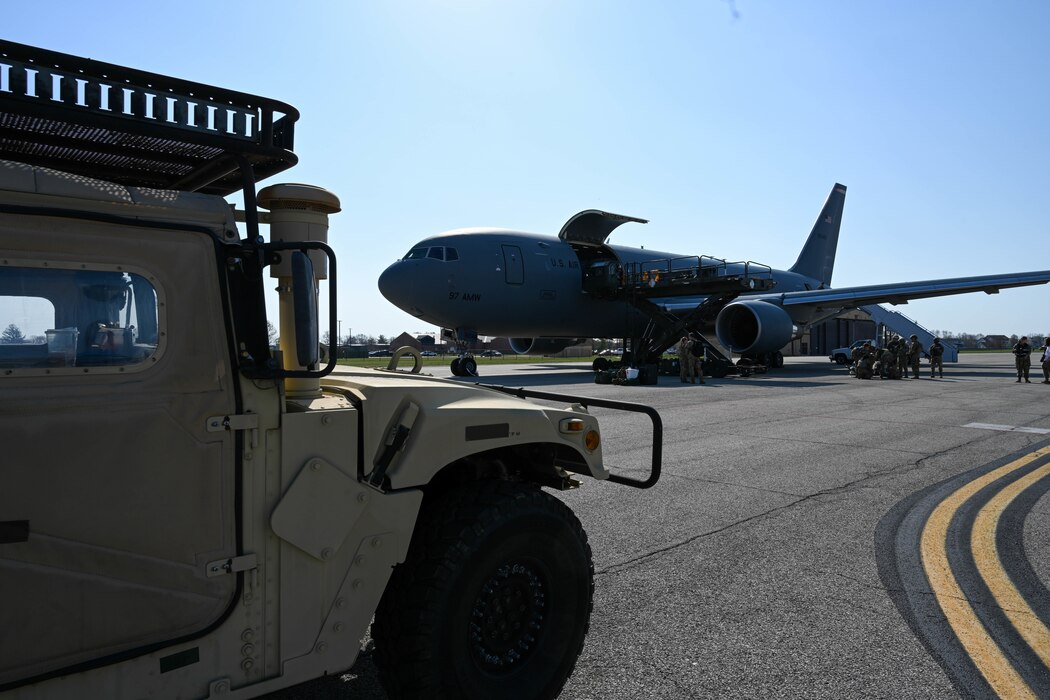 A KC-46 Pegasus from the 56th Air Refueling Squadron and a humvee from the 375th Air Mobility Wing sit on the flightline during Combat Cardinal 2024 at Scott Air Force Base, Illinois, March 13, 2024. The KC-46 added an opportunity for Aeromedical Evacuation specialists to hone their mission essential skills during the exercise. (U.S. Air Force photo by Senior Airman Trenton Jancze)