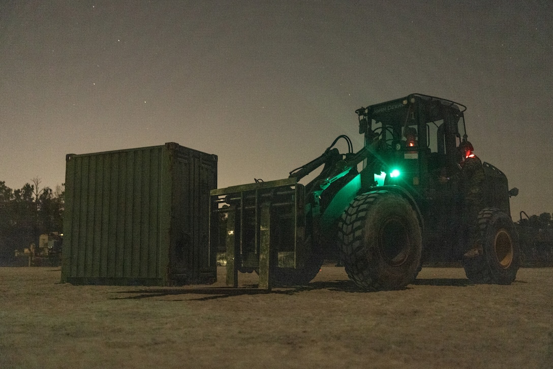 A U.S. Marine with 8th Engineer Support Battalion, Combat Logistics Regiment 27, 2nd Marine Logistics Group, stages a Tractor Rubber-Tired Articulated Steering Multi-Purpose vehicle on Camp Lejeune, North Carolina, March 20, 2024. Marines with 8th DSB utilized night vision equipment while operating TRAM vehicles in a low light environment to prepare for future night operations and sustaining combat readiness. (U.S. Marine Corps photo by Cpl. Mary Kohlmann)