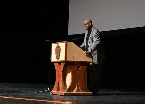 Edmond Mayor speaks to high school students from podium.