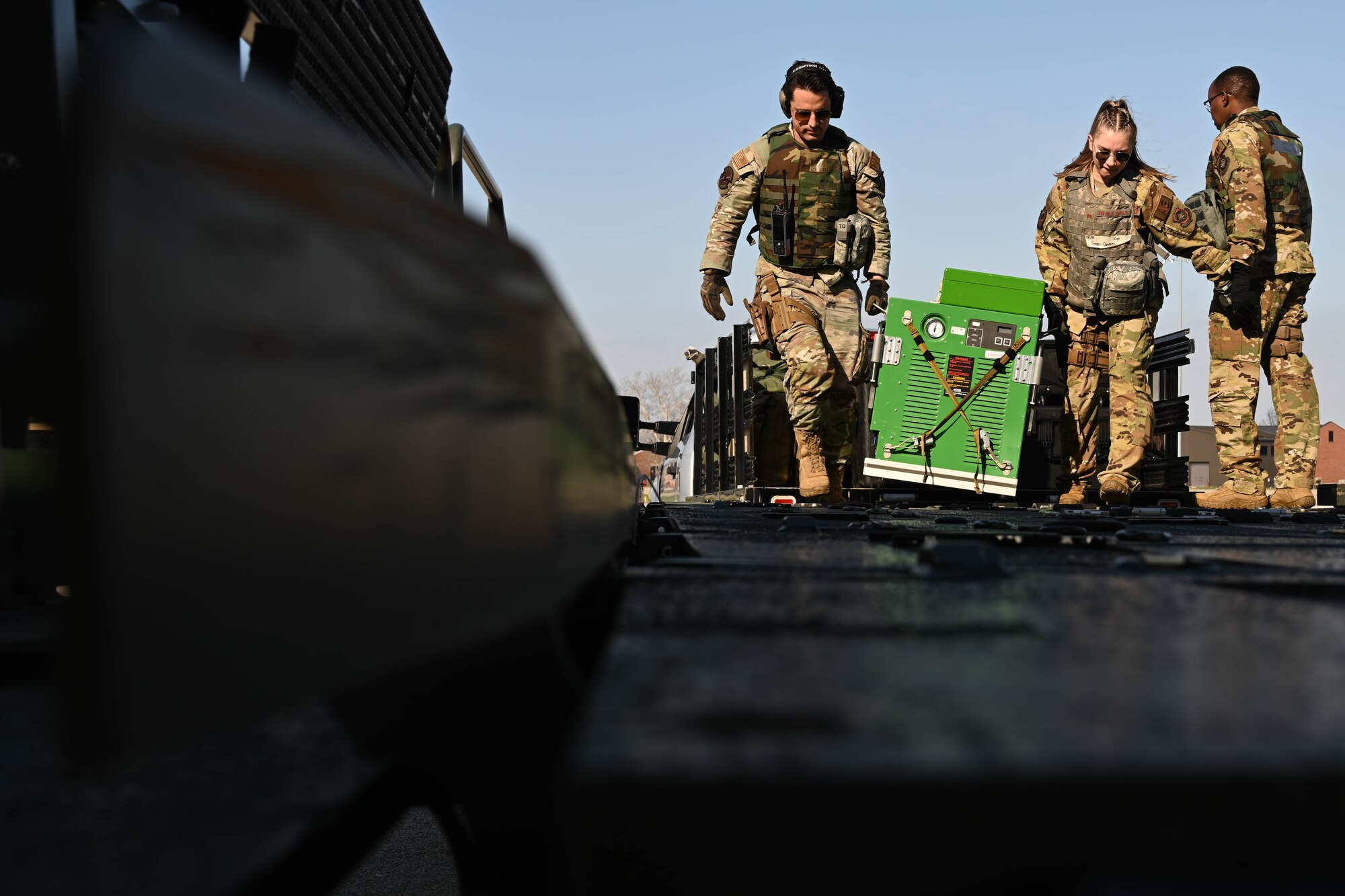 U.S. Air Force Senior Airman Gabriel Vidana, left, 375th Logistics Readiness Squadron aeromedical transportation technician, and Staff Sgt. Sarah Cardenas, 375th Aeromedical Evacuation Squadron medical technician, carry equipment onto a Tunner 60K Aircraft Cargo Loader/Transporter on the flightline during Combat Cardinal 2024 at Scott Air Force Base, Illinois, March 13, 2024. Combat Cardinal is a series of training exercises meant to enhance Air Mobility Command’s ability to quickly and effectively “Explode into Theater,” having the readiness capability to sense and seize opportunities during a conflict. (U.S. Air Force photo by Senior Airman Trenton Jancze)