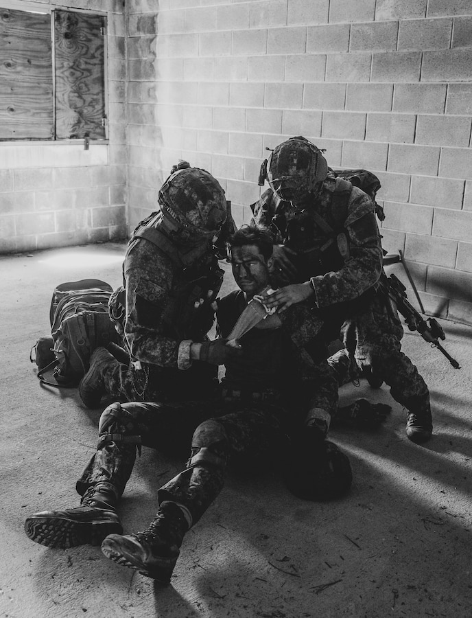Dutch Marines with Marine Squadron Carib, Netherlands Marine Corps treat a simulated casualty during Exercise Caribbean Urban Warrior on Camp Lejeune, North Carolina, March 21, 2024. Exercise Caribbean Urban Warrior is a bilateral training evolution designed to increase global interoperability between 2d Marine Division and Marine Squadron Carib. (U.S. Marine Corps photo illustration by Lance Cpl. Emma Gray)