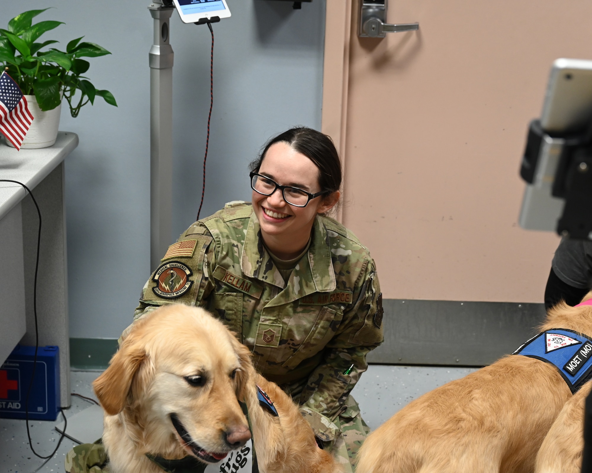 A women in uniform visits with a Golden Retriever at the New England USO at Westover on April 6, 2024.