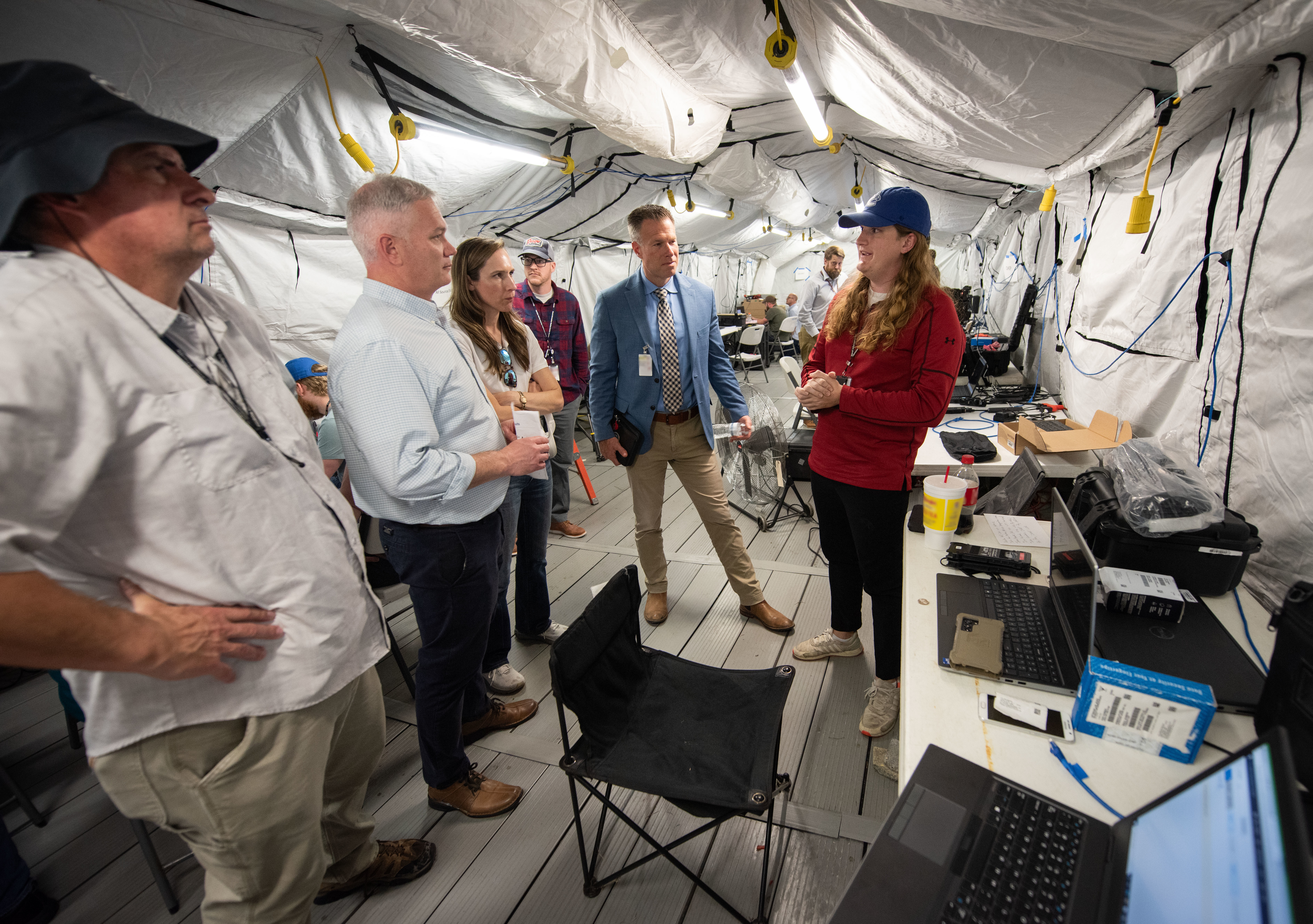 Timothy Gramp (blue jacket), deputy to the commander at Marine Corps Systems Command for systems engineering, acquisition and logistics, receives a briefing on March 18 from members of the Expeditionary Warfare Department at Naval Information Warfare Center Atlantic during the annual System of Systems Naval Integration Experiment.