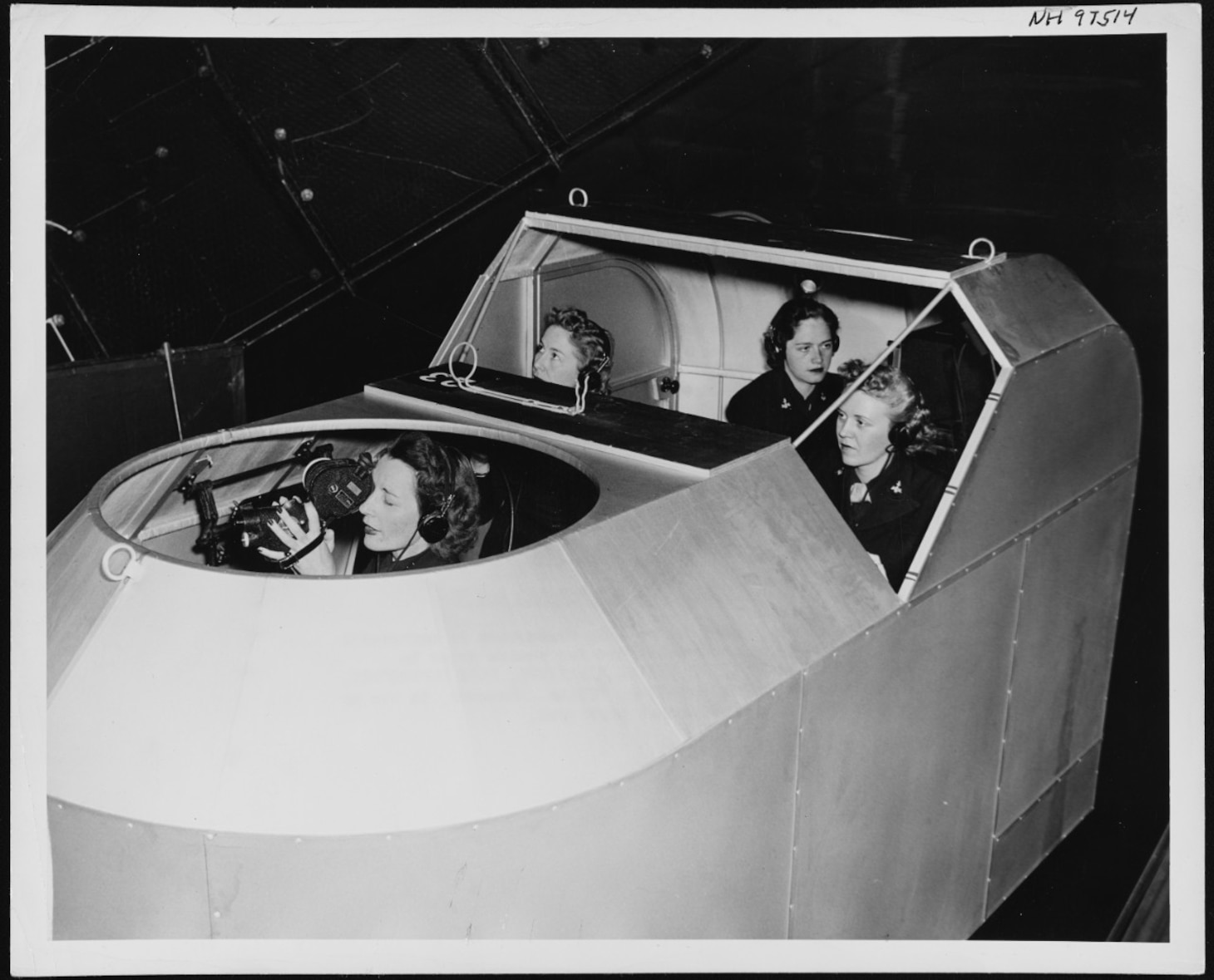 Specialists (Teachers) rotate duties on practice “flights” in the Celestial Navigation Trainer (CNT) on July 23, 1944. These WAVES are attending the 10-week Navy Link Celestial Navigation School located at Naval Air Station Seattle. Pictured (left to right):  Irene Aide, navigator; Linnea Peterson, instructor; Jane Hall, radio operator; and Elinor Johnson, pilot.