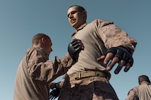 U.S. Marine Corps recruits Bryce Grimm, left, and Tyler Crisp, right, with Fox Company, 2nd Recruit Training Battalion, execute Marine Corps Martial Arts Program techniques during a training event at Marine Corps Recruit Depot San Diego, California, March 18, 2024. MCMAP aims to strengthen the mental and moral resiliency of individual recruits and Marines through realistic combative training, warrior ethos studies, and physical hardening. (U.S. Marine Corps photo by Cpl. Alexander O. Devereux)