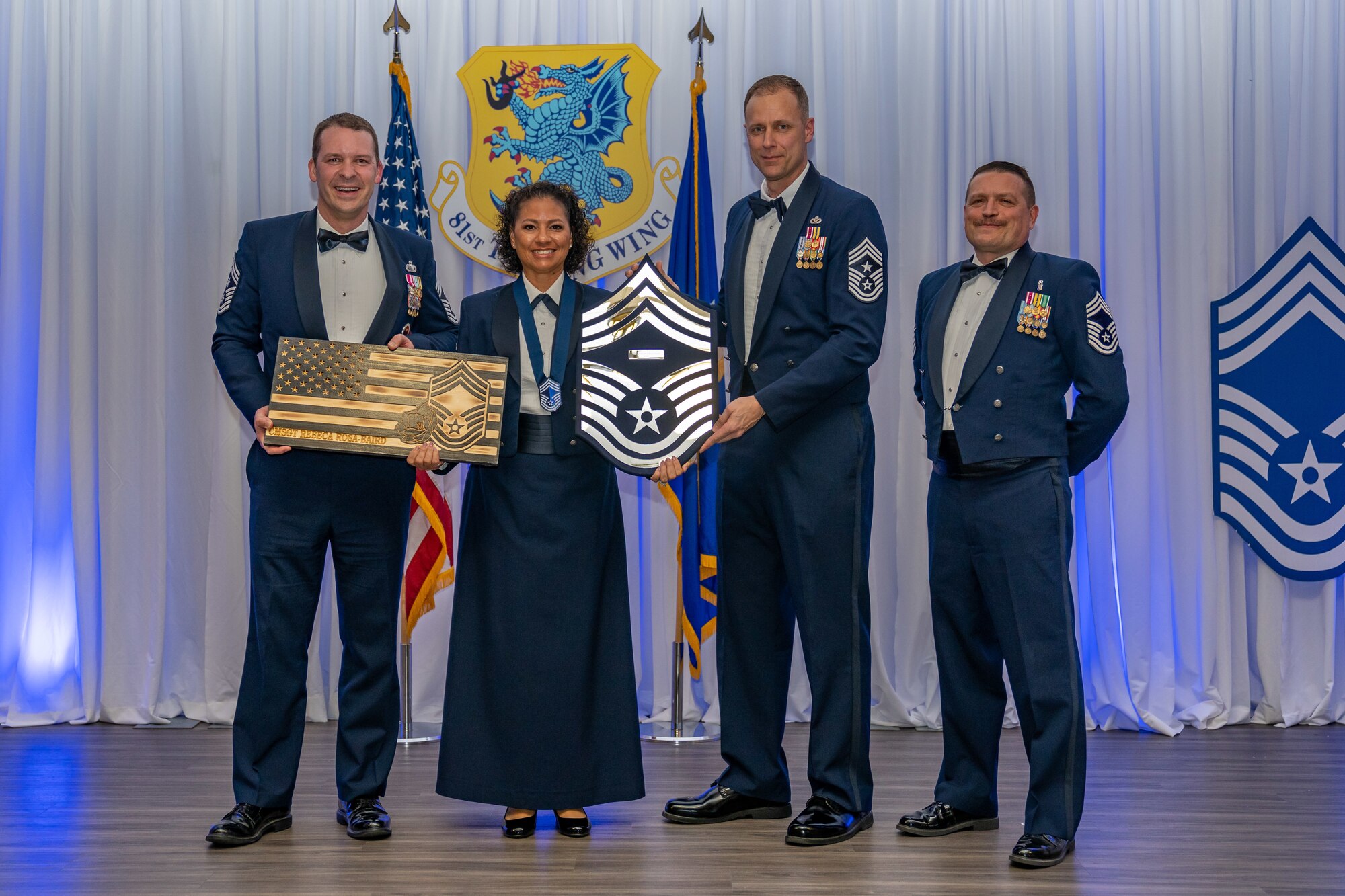 U.S. Air Force Senior Master Sgt. Rebeca Rosa-Baird, 81st Comptroller Squadron senior enlisted leader, receives two plaques in recognition of attaining chief master sergeant during the Chief Master Sergeant Recognition Ceremony at Keesler Air Force Base, Mississippi, March 15, 2024. Two Keesler Airmen earned their chief master sergeant stripe during the 2023 promotion release. Chief master sergeants make up 1% of the Air Force enlisted force. (U.S. Air Force photo by Andrew Young)
