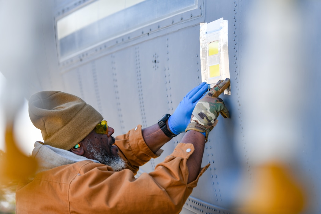 Arthur Harris Jr., an equipment specialist from the Warner Robins Air Logistics Complex C-130 System Program Office, Georgia, fastens a droplet sample card to the tail section of a C-130J-30 Super Hercules aircraft at Youngstown Air Reserve Station, Ohio, March 25, 2024.