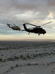 UH-60L and CH-53 helicopters flying at Yuma Proving Ground in Arizona.
