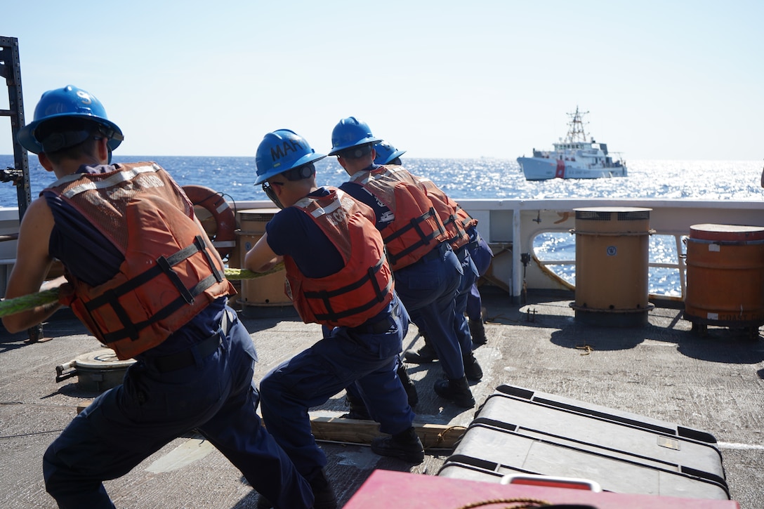 The crew of U.S. Coast Guard Cutter Venturous (WMEC 625) throws a heaving line to the crew of the U.S. Coast Guard Cutter Bernard C. Webber (WPC 1101) during a towing exercise near the Windward Passage, Feb. 28, 2024. Both cutters patrol within the Coast Guard's Seventh District area of responsibility.