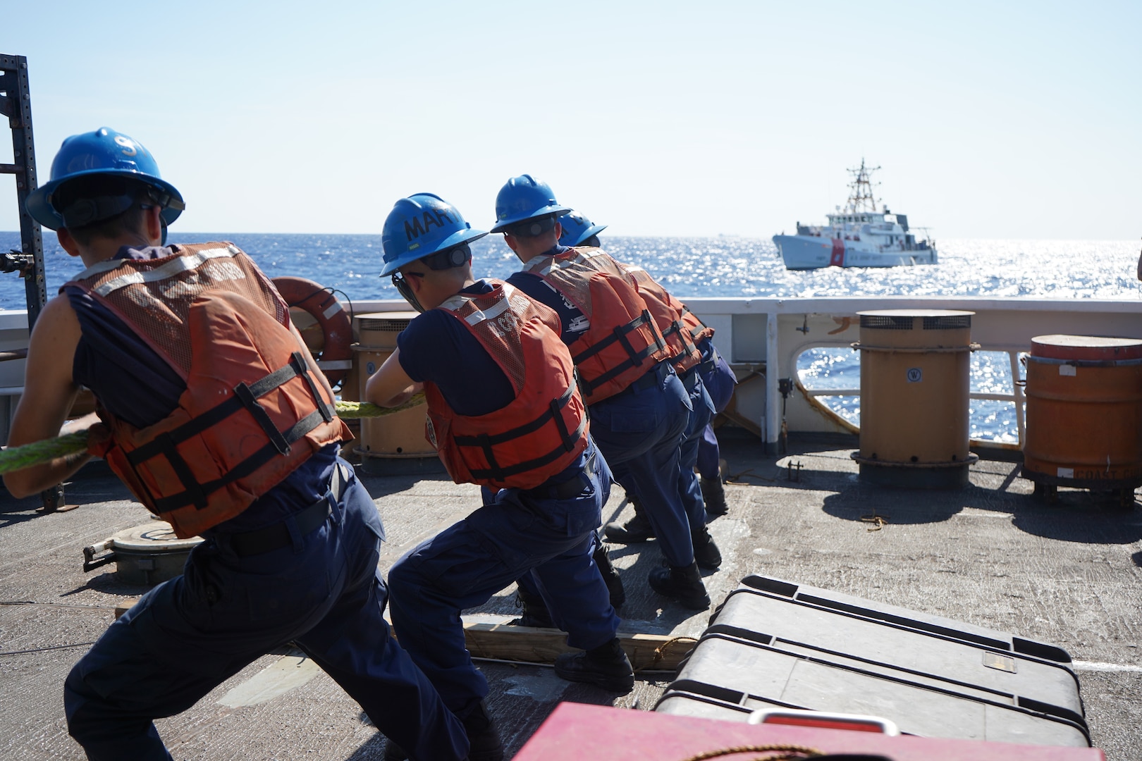 The crew of U.S. Coast Guard Cutter Venturous (WMEC 625) throws a heaving line to the crew of the U.S. Coast Guard Cutter Bernard C. Webber (WPC 1101) during a towing exercise near the Windward Passage, Feb. 28, 2024. Both cutters patrol within the Coast Guard's Seventh District area of responsibility.