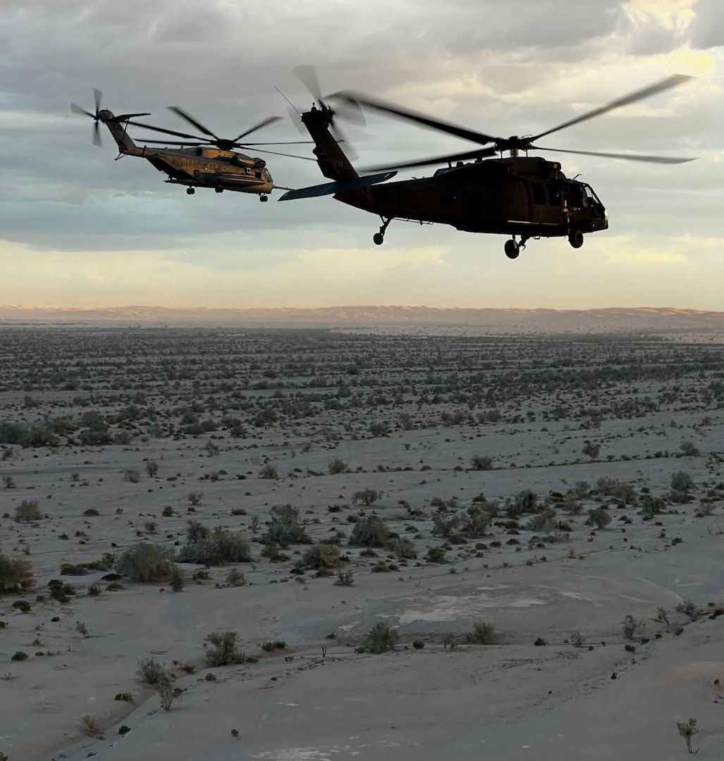 UH-60L and CH-53 helicopters flying at Yuma Proving Ground in Arizona.