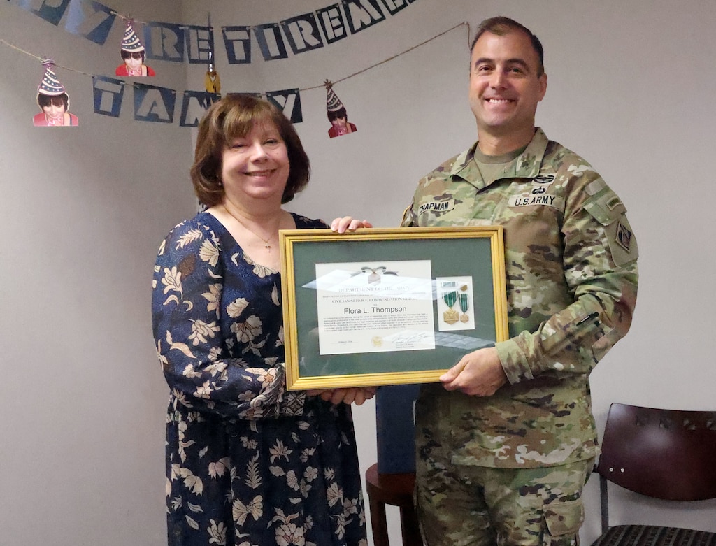 Woman receives award from man.
