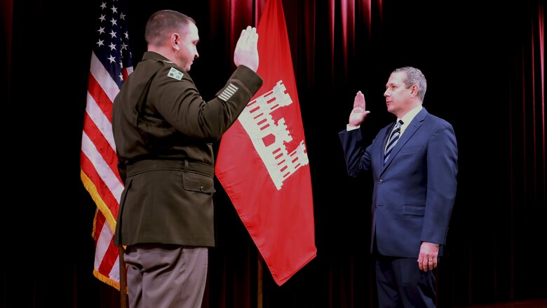 Lt. Col. Robert Green, U.S. Army Corps of Engineers Nashville District commander, re-administers the civilian oath of office with Craig Carrington as part of his assumption of responsibility for his new position as deputy district engineer during a ceremony at the Nashville Public Library in Nashville, Tennessee. (USACE Photo by Sarah Steffens)