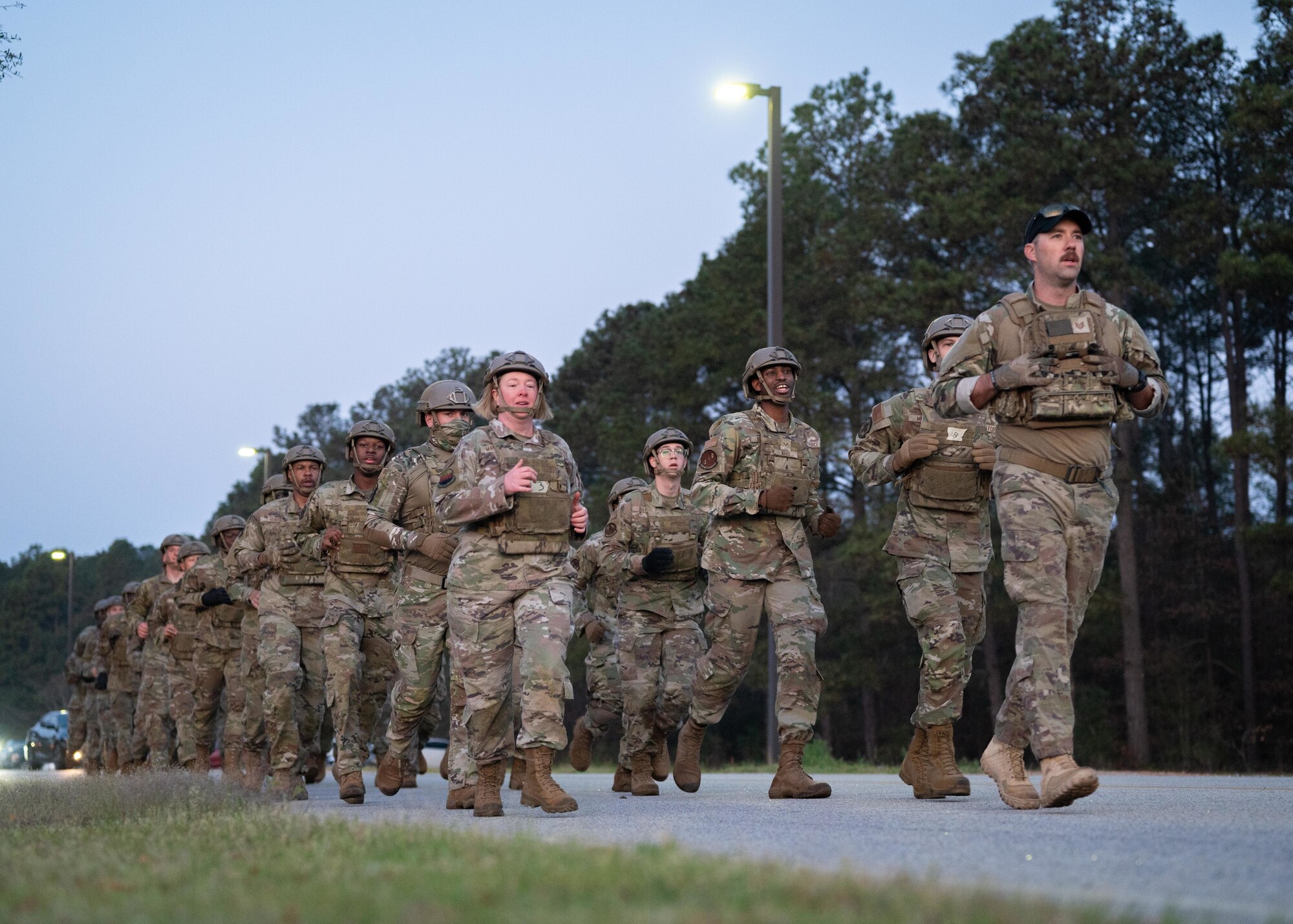 A group of Airmen perform a ruck.