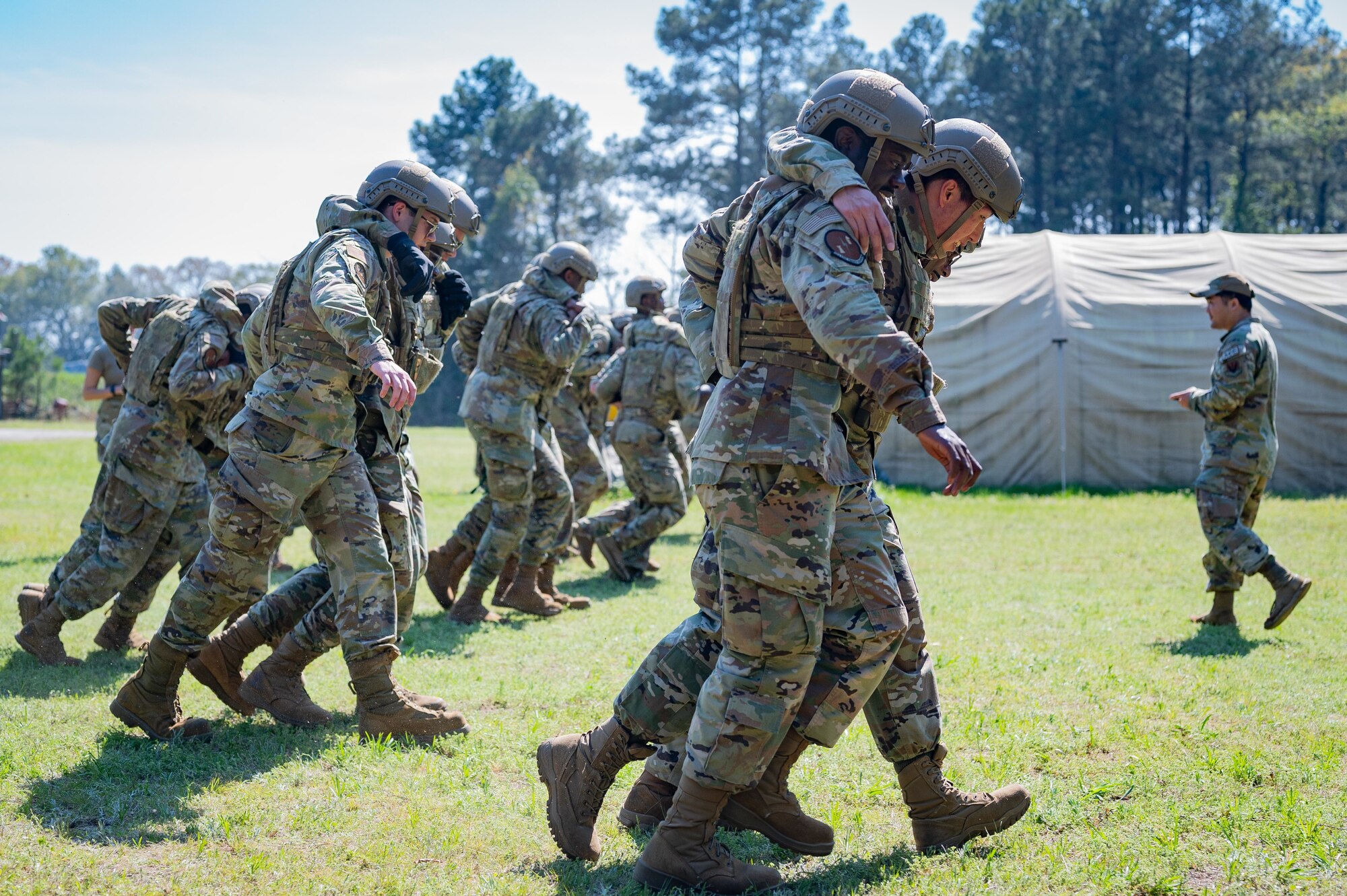 A group of Airmen practice tactical carry techniques.