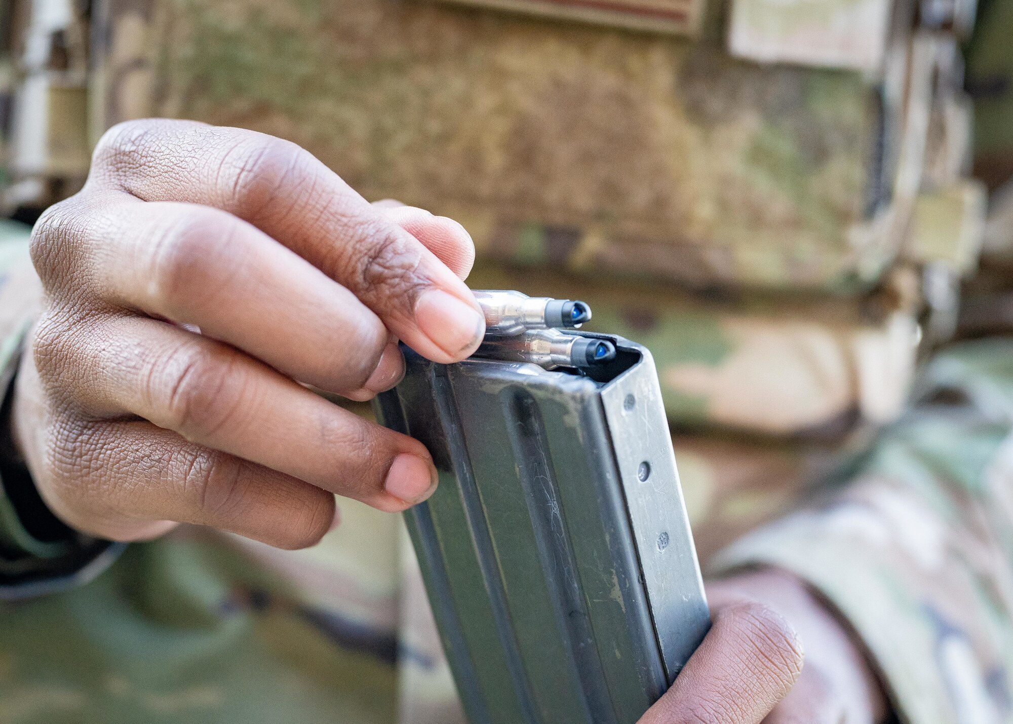 An Airman loads a magazine.