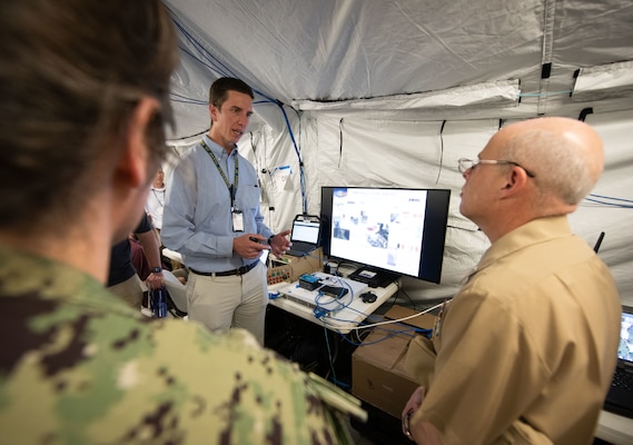 Chief of Naval Research Rear Adm. Kurt Rothenhaus receives briefings at Naval Information Warfare Center Atlantic on March 21 from members of the Expeditionary Warfare Department and the Science and Technology Department during the command’s annual System of Systems Naval Integration Experiment.