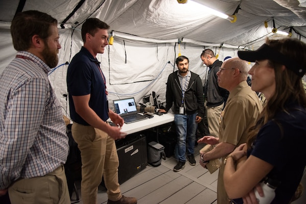 Chief of Naval Research Rear Adm. Kurt Rothenhaus receives briefings at Naval Information Warfare Center Atlantic on March 21 from members of the Expeditionary Warfare Department and the Science and Technology Department during the command’s annual System of Systems Naval Integration Experiment.
