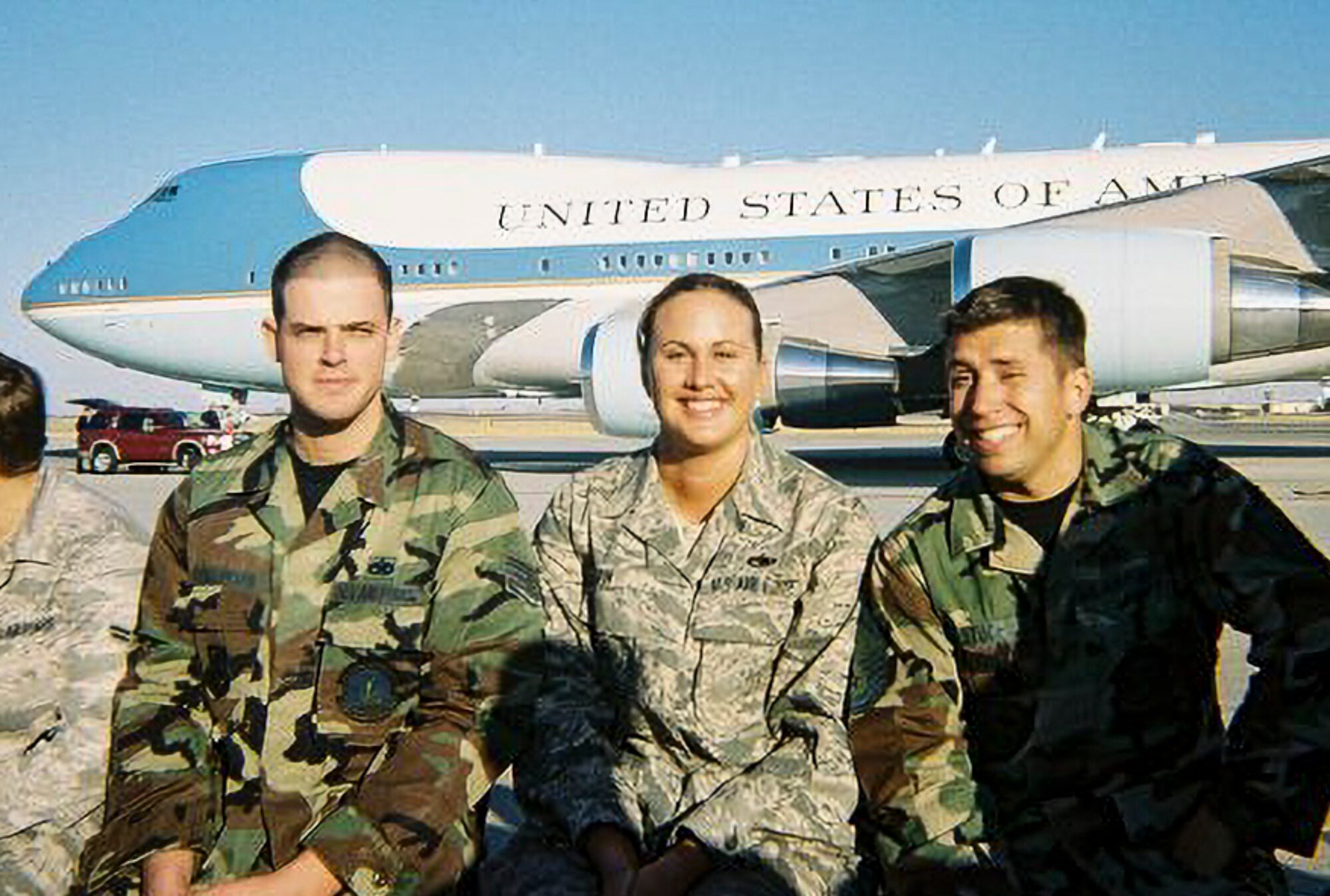 U.S. Air Force Senior Airman Jennifer Barger, 60th Aircraft Maintenance Squadron crew chief (center), sits with other maintenance Airmen as they pose for a picture in front of Air Force One when President George W. Bush visited Travis Air Force Base, California in 2005.