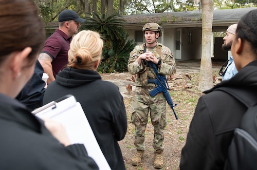 Contestants evaluate mock crime scene