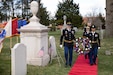 U.S. Army Reserve Sgt. Major Robert Harris, Training Management Sergeant Major of the 99th Readiness Division and 1st Sgt. Martha Cotto, First Sergeant of the 99th Headquarters and Headquarters Detachment carry the wreath to President Grover Cleveland’s grave, along with US Army Maj. Gen. Kris A. Belanger, Commanding General, 99th Readiness Division and Princeton Mayor Mark Freda Princeton Cemetery, Princeton, New Jersey, March 18, 2024. The two non-commissioned officers volunteered for the special event held annually on former President Cleveland’s birthday. (U.S. Army Photo by Sgt. Emilie Lenglain)