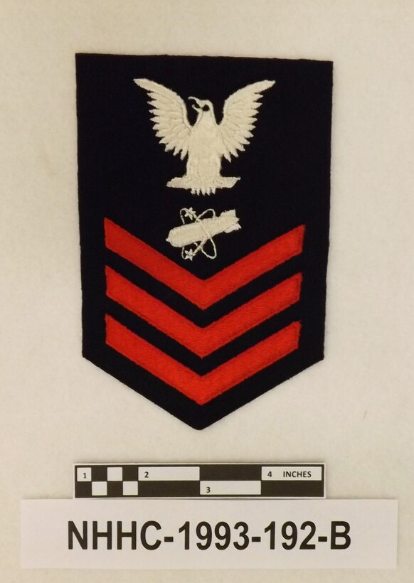 Nuclear weaponsman first class (NW1) rating badge. (NHHC-1993-192-B)