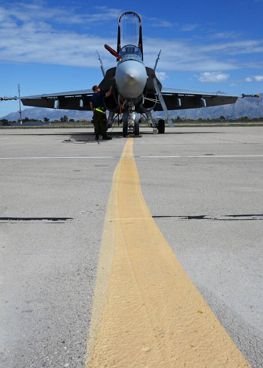 A CF-18 Hornet assigned to the Royal Canadian air force, undergoes routine maintenance during Exercise Cougar South at Davis-Monthan Air Force Base, Ariz., March 14, 2024. The exercise included scenario-based missions, air combat tactics, close air support training, air-to-air refueling training, and employment of precision-guided munitions. (U.S. Air Force photo by Staff Sgt. Abbey Rieves)