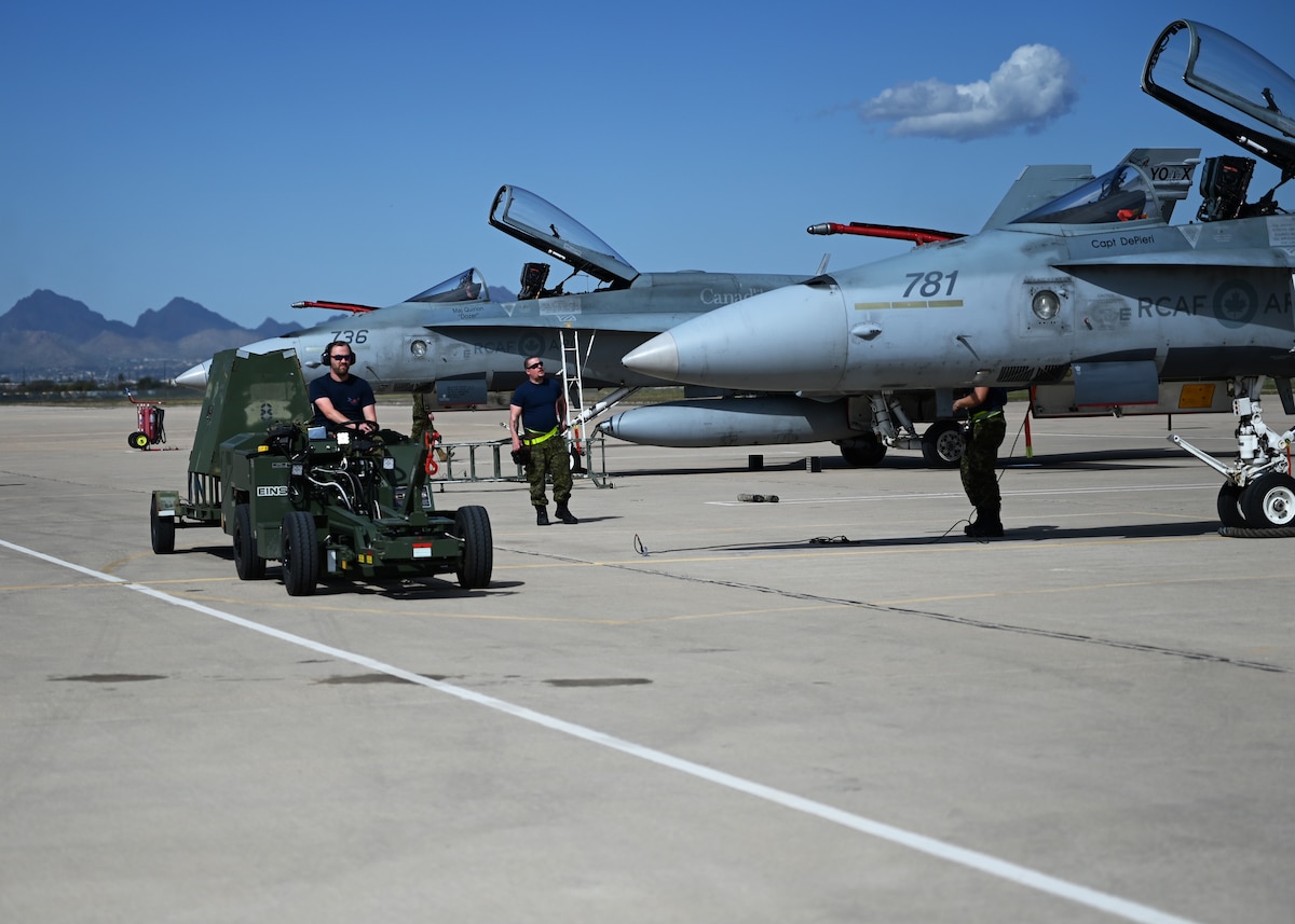 Royal Canadian air force members conduct routine maintenance during Exercise Cougar South at Davis-Monthan Air Force Base, Ariz., March 14, 2024. The exercise allowed the RCAF’s CF-18 Hornet aircraft and U.S. Air Force F-16 Fighting Falcon aircraft to train in team dogfight scenarios. (U.S. Air Force photo by Staff Sgt. Abbey Rieves)