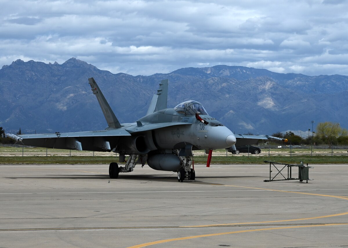A Royal Canadian air force CF-18 Hornet aircraft is on the flight line during Exercise Cougar South at Davis-Monthan Air Force Base, Ariz., March 14, 2024. The exercise was an 8-week mission designed to strengthen coalition experiences and better prepare allied partners for future warfare. (U.S. Air Force photo by Staff Sgt. Abbey Rieves) NOTE: this photo has been altered to obscure the visibility of the avionic system to maintain the security of the aircraft.