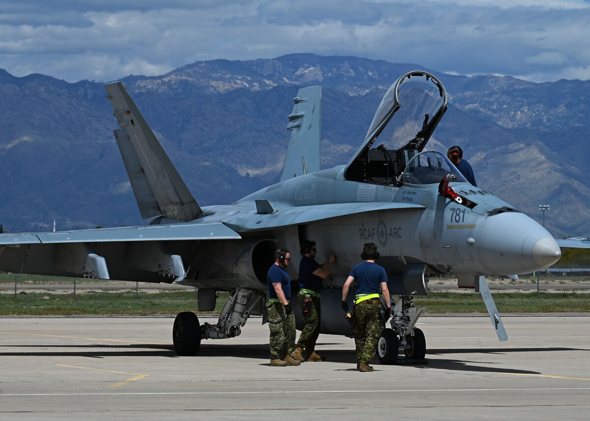 Royal Canadian air force members conduct routine maintenance on a CF-18 Hornet aircraft during Exercise Cougar South at Davis-Monthan Air Force Base, Ariz., March 14, 2024. The RCAF defends and protects Canadian and North American airspace in partnership with the U.S. (U.S. Air Force photo by Staff Sgt. Abbey Rieves)