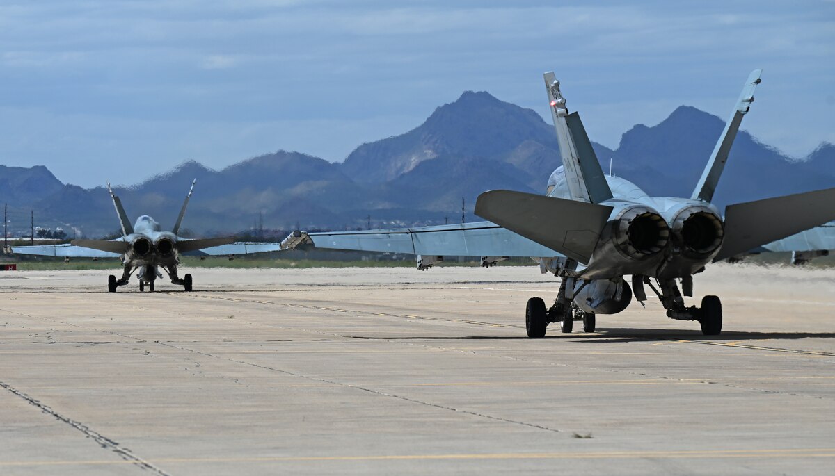 Two CF-18 Hornet aircraft assigned to the Royal Canadian air force taxi during Exercise Cougar South at Davis-Monthan Air Force Base, Ariz., March 14, 2024. ECS was an eight-week training mission designed to enhance tactical fighter readiness and weapon maintenance in the Northern Atlantic Treaty Organization. (U.S. Air Force photo by Staff Sgt. Abbey Rieves)