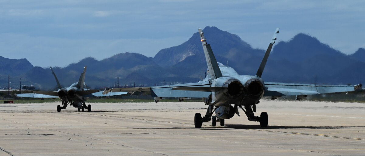 Two CF-18 Hornet aircraft assigned to the Royal Canadian air force taxi during Exercise Cougar South at Davis-Monthan Air Force Base, Ariz., March 14, 2024. ECS was an eight-week training mission designed to enhance tactical fighter readiness and weapon maintenance in the Northern Atlantic Treaty Organization. (U.S. Air Force photo by Staff Sgt. Abbey Rieves)