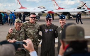 Luke Air Force Base key leadership pose for a photo in front of U.S. Air Force F-16 Fighting Falcons, assigned to the U.S. Air Force Demonstration team, the "Thunderbirds," following the final act of the Luke Days 2024 Airshow.