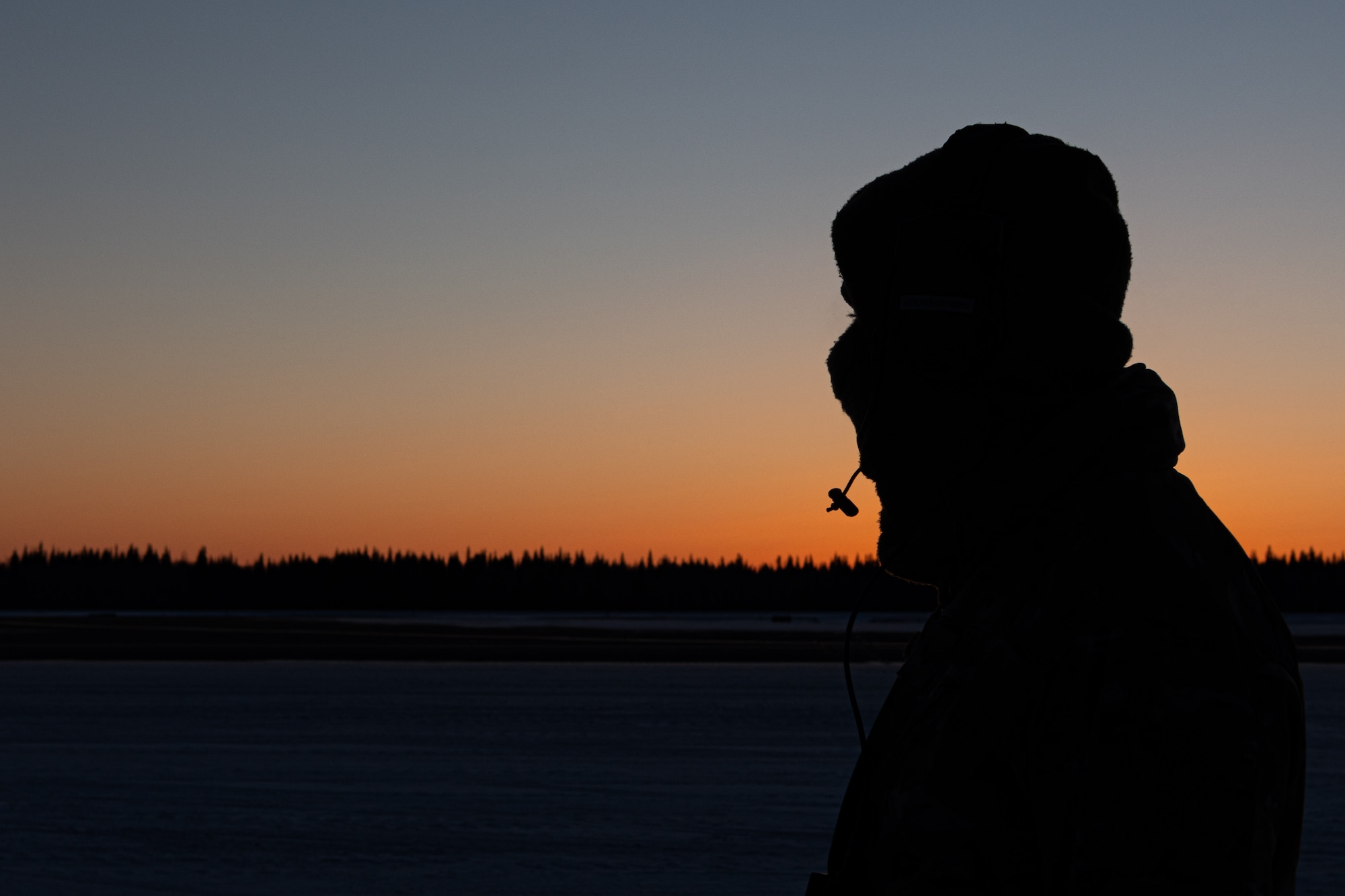 A U.S. Airman assigned to the 27th Special Operations Wing checks the rear of a MC-130J Commando II at sunset during Arctic Edge 24 in Fairbanks, Alaska, Feb. 29, 2024. AE24 is an annual defense exercise for the U.S. Northern Command emphasizing Joint Force operations in an extreme cold weather and high latitude environment and is designed to demonstrate Globally Integrated Layered Defense in the Arctic. (U.S. Air Force photo by Senior Airman Drew Cyburt)