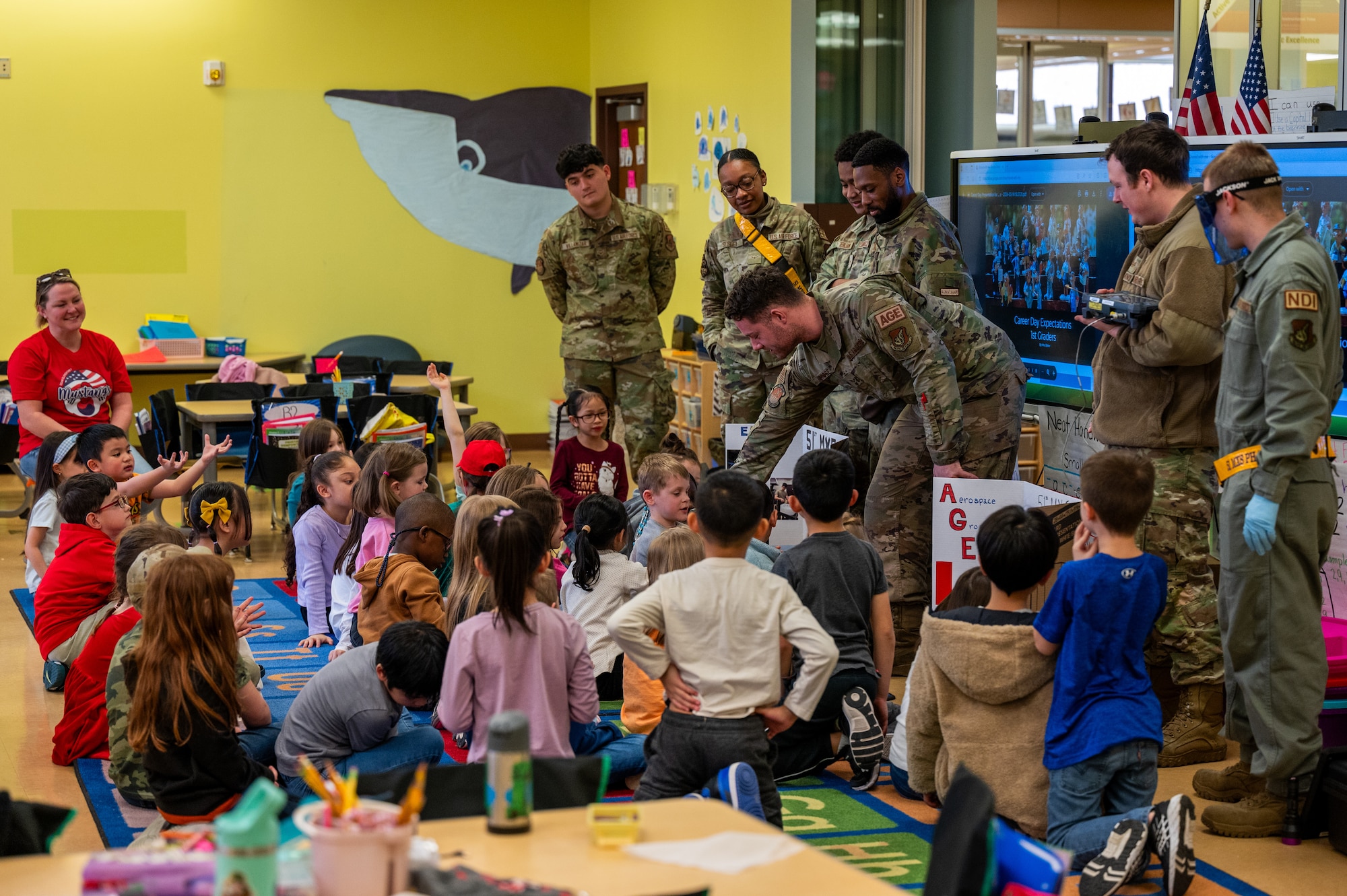 U.S. Air Force Airmen assigned to the 51st Maintenance Squadron give a presentation on their careers to Osan Elementary School students during career day at Osan Air Base, Republic of Korea, March 15, 2024. The volunteers organized simple activities for the students to participate in, aiming to enhance their educational experience. (U.S. Air Force photo by Airman 1st Class Chase Verzaal)