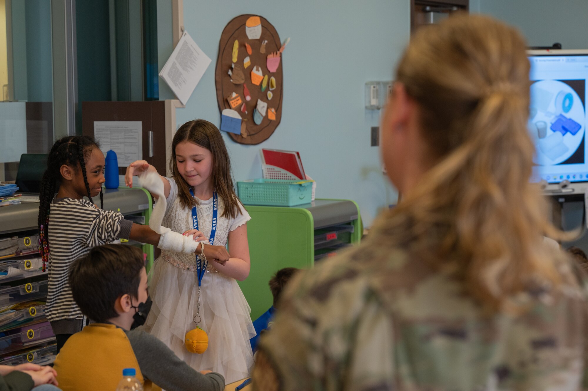 U.S. Air Force Lt. Col. Susan Joseph, 51st Medical Group commander, hosts an activity with Osan Elementary School students as part of her presentation for career day at Osan Air Base, Republic of Korea, March 15, 2024. Career day provided OES students with presenters who shared personal experience in the workforce with the ultimate goal to inspire consideration of a wider variety of jobs. (U.S. Air Force photo by Airman 1st Class Chase Verzaal)