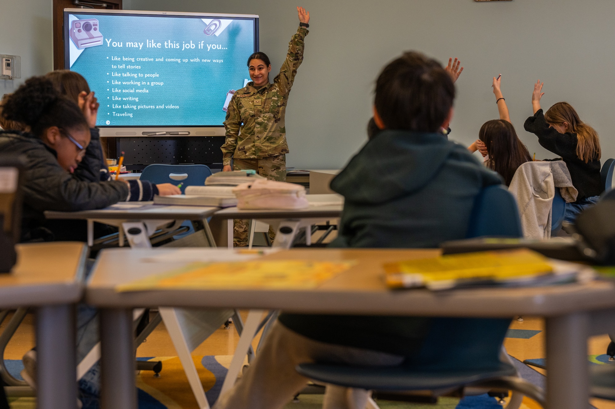 U.S. Air Force Senior Airman Kaitlin Frazier, 51st Fighter Wing public affairs journeyman, asks Osan Elementary School students questions during a career day presentation at Osan Air Base, Republic of Korea, March 15, 2024. The volunteers shared stories about their careers, and encouraged the students to work hard in school to create more opportunities for themselves in the future. (U.S. Air Force photo by Airman 1st Class Chase Verzaal)