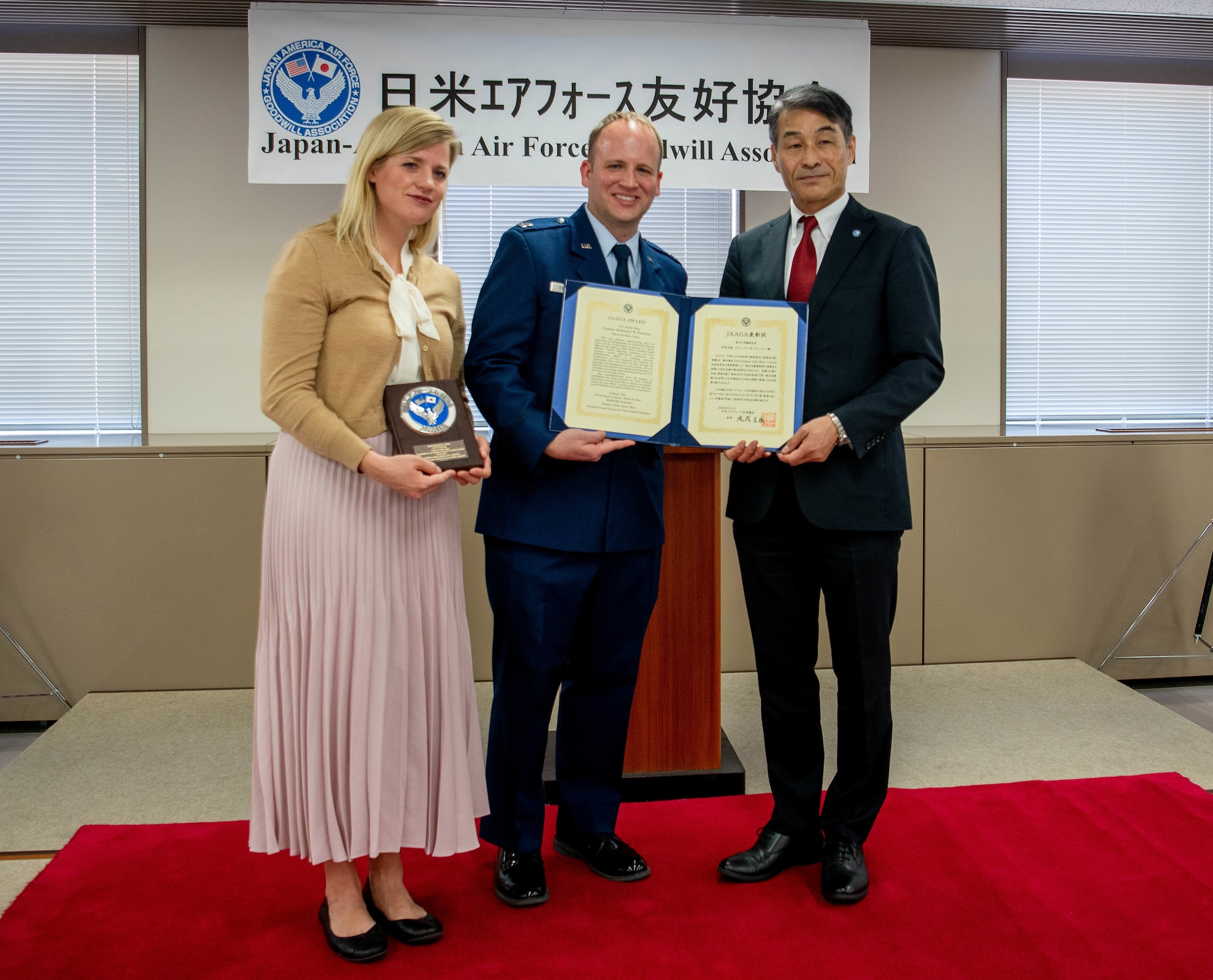 U.S. Air Force Capt. Nathaniel Freeman, 374th Airlift Wing legal office chief of international law, receives an award.