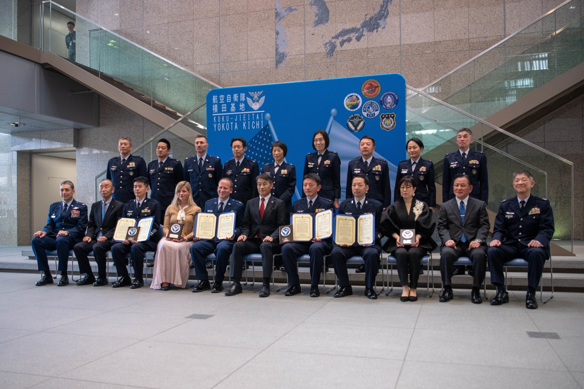 Members of the 374th Airlift Wing, Operations Support Wing and Japan-America Air Force Goodwill Association (JAAGA) pose for a commemorative photo.