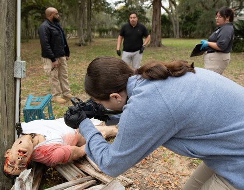 Contestants evaluate mock crime scene