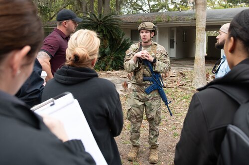 Contestants evaluate mock crime scene