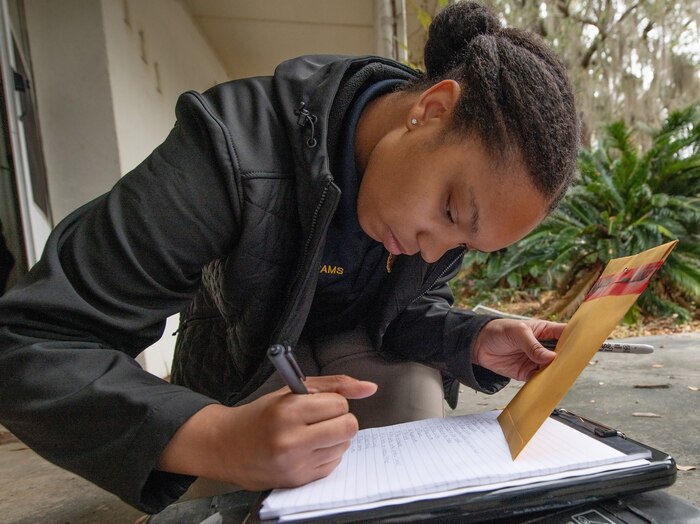 lab analyst, prepares evidence of a set of mock footprints