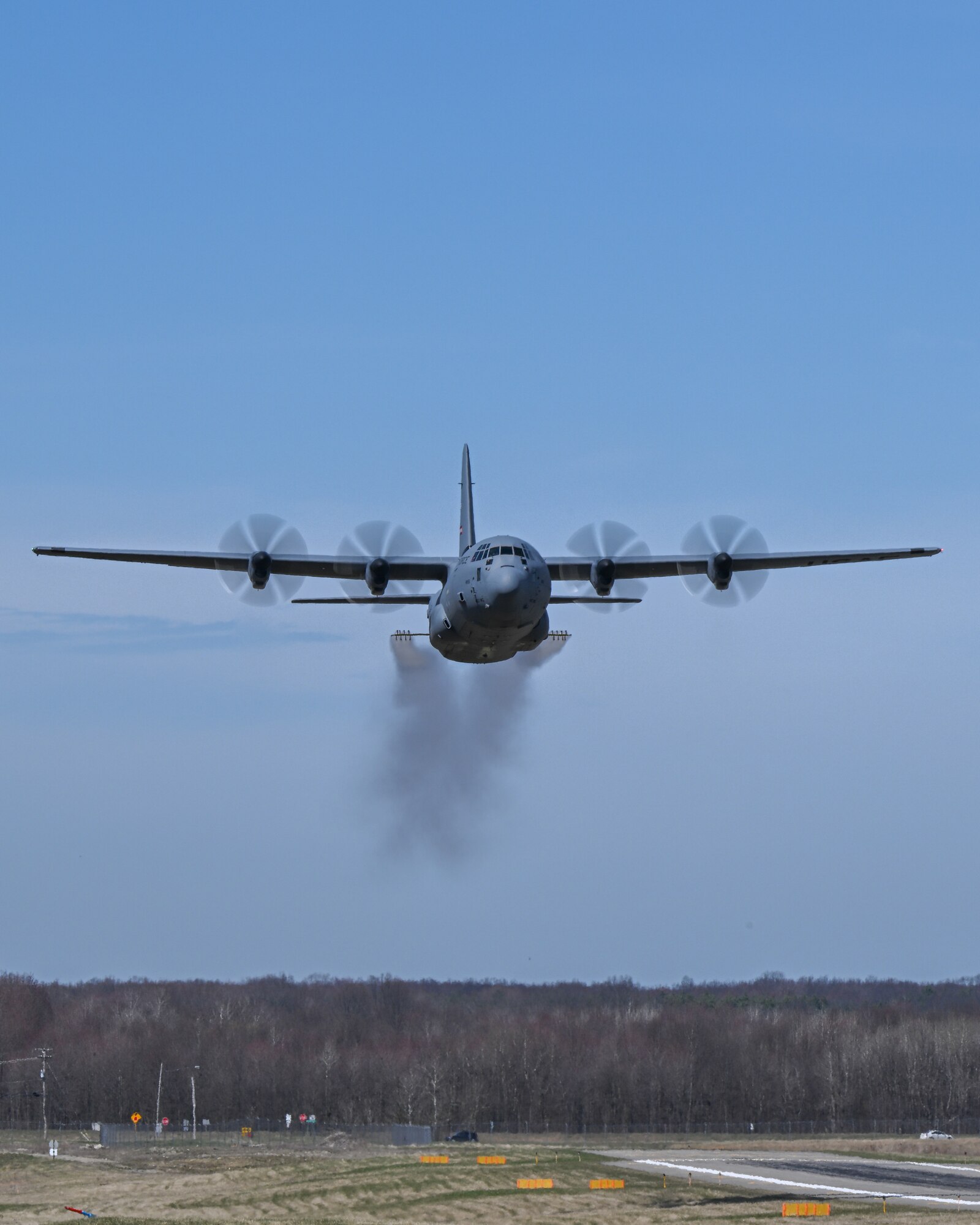 A C-130J-30 Super Hercules aircraft from Keesler Air Force Base, Mississippi, sprays water during a low pass at Youngstown Air Reserve Station, Ohio, as part of a flight test of the 910th Airlift Wing's unique electronic modular aerial spray system, March 25, 2024.