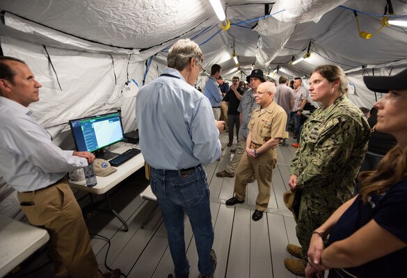 Chief of Naval Research Rear Adm. Kurt Rothenhaus receives briefings at Naval Information Warfare Center Atlantic on March 21 from members of the Expeditionary Warfare Department and the Science and Technology Department during the command’s annual System of Systems Naval Integration Experiment.