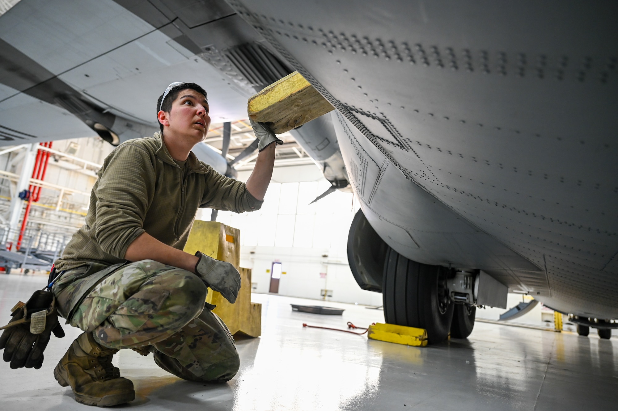 Senior Airman Khala Walls, an aerospace maintainer with the 910th Maintenance Squadron, wedges a troop door on a C-130J-30 Super Hercules aircraft from Keesler Air Force Base, Mississippi, visiting Youngstown Air Reserve Station, Ohio, March 19, 2024.