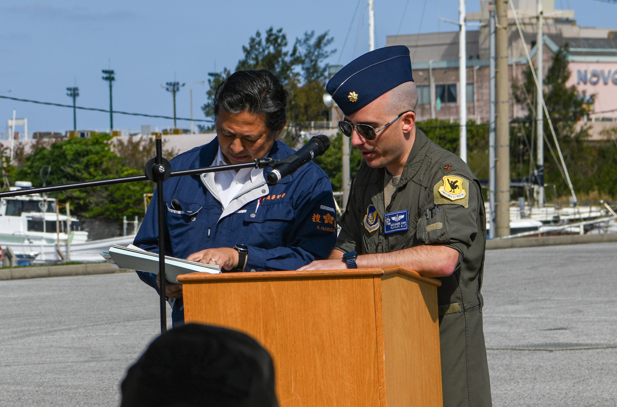 U.S. Air Force Major Alexander Kipp, right, 18th Wing Plans and Programs deputy chief, gives opening remarks.