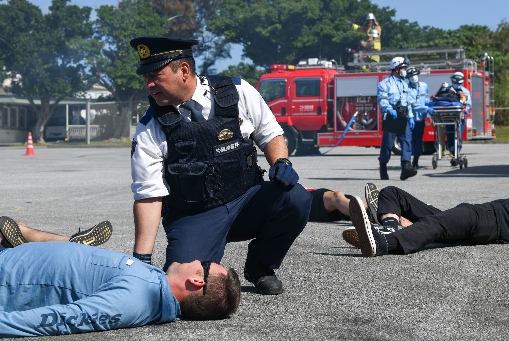 Okinawa emergency responders aid simulated victims in a bilateral aircraft mishap response field exercise.