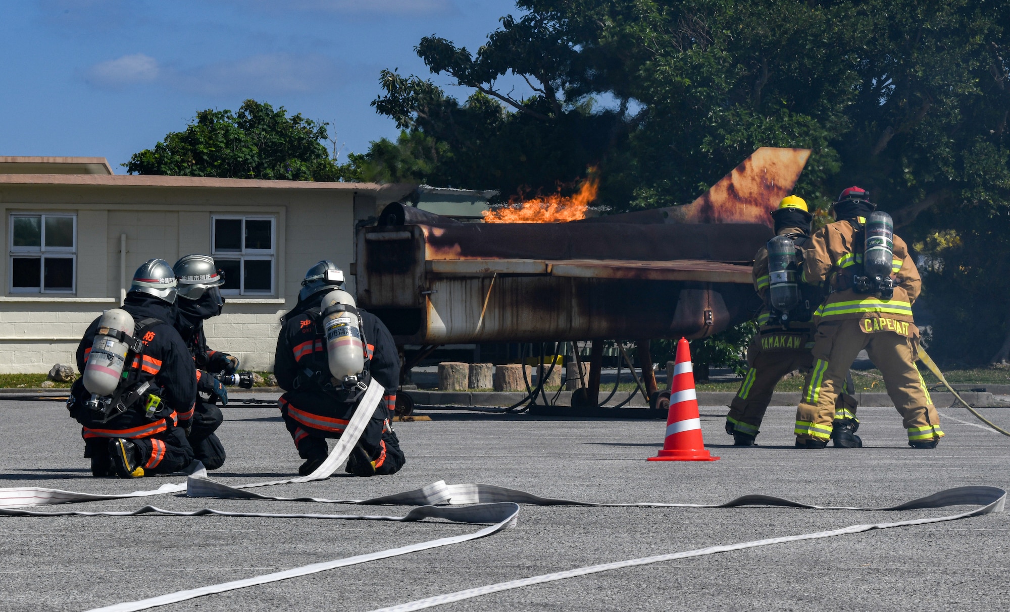Okinawa emergency responders simulate extinguishing an aircraft fire.