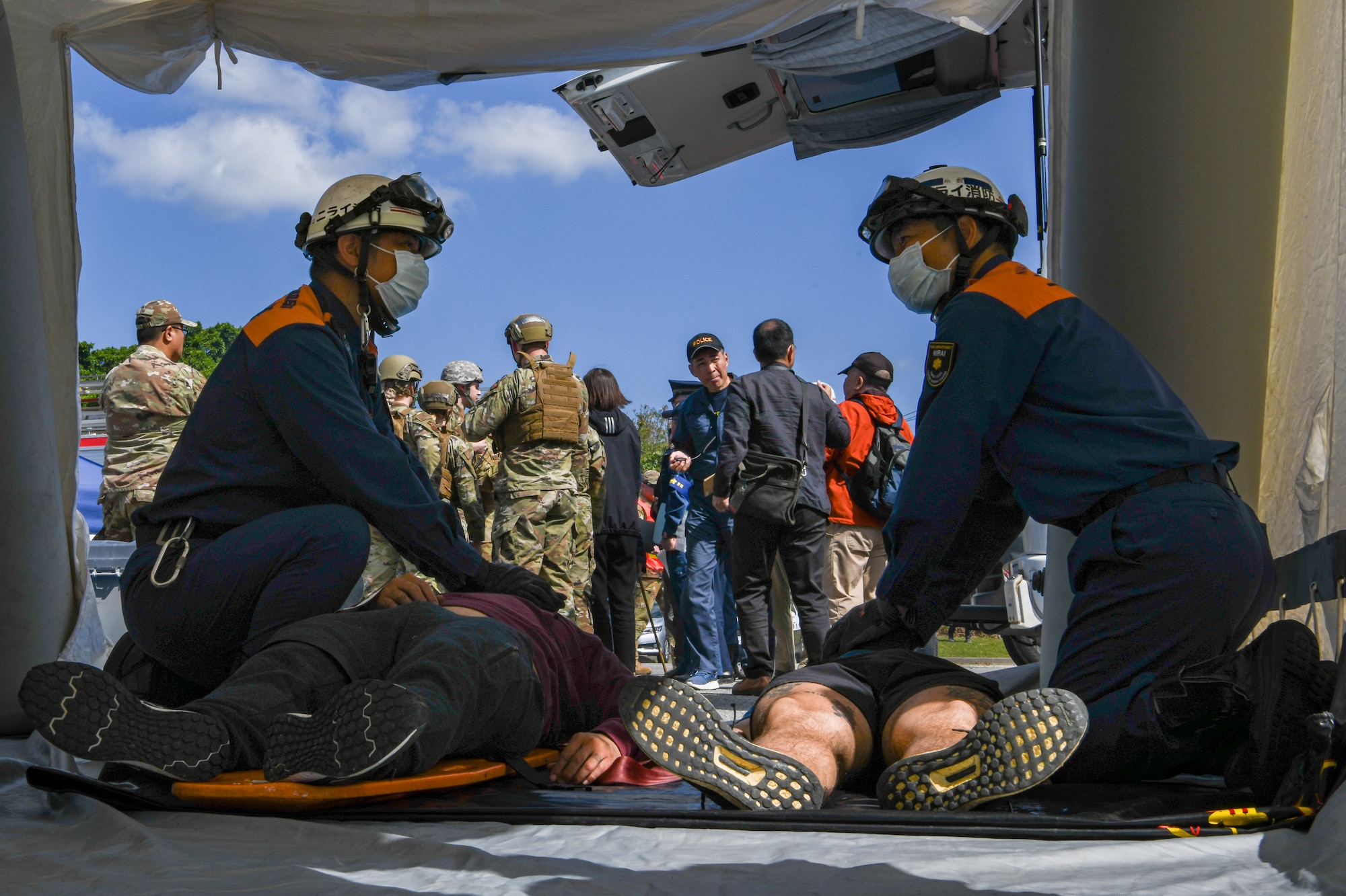 Okinawa emergency responders provide aid to simulated victims.